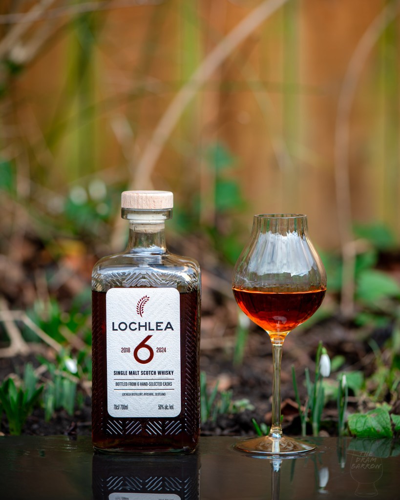 Lochlea 6 Year Old Whisky in front of snowdrops