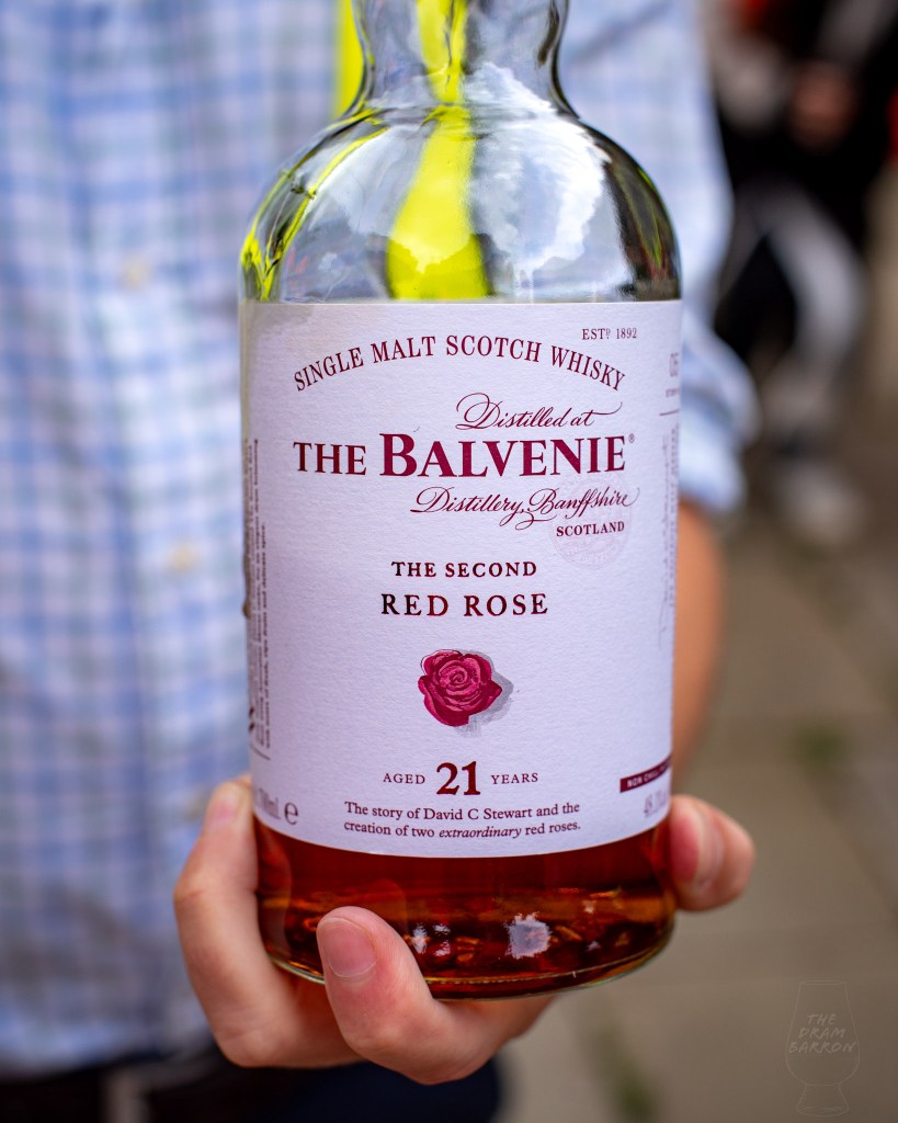 Picture of man holding a bottle of The Balvenie 21 Year Old The Second Red Rose Whisky up close